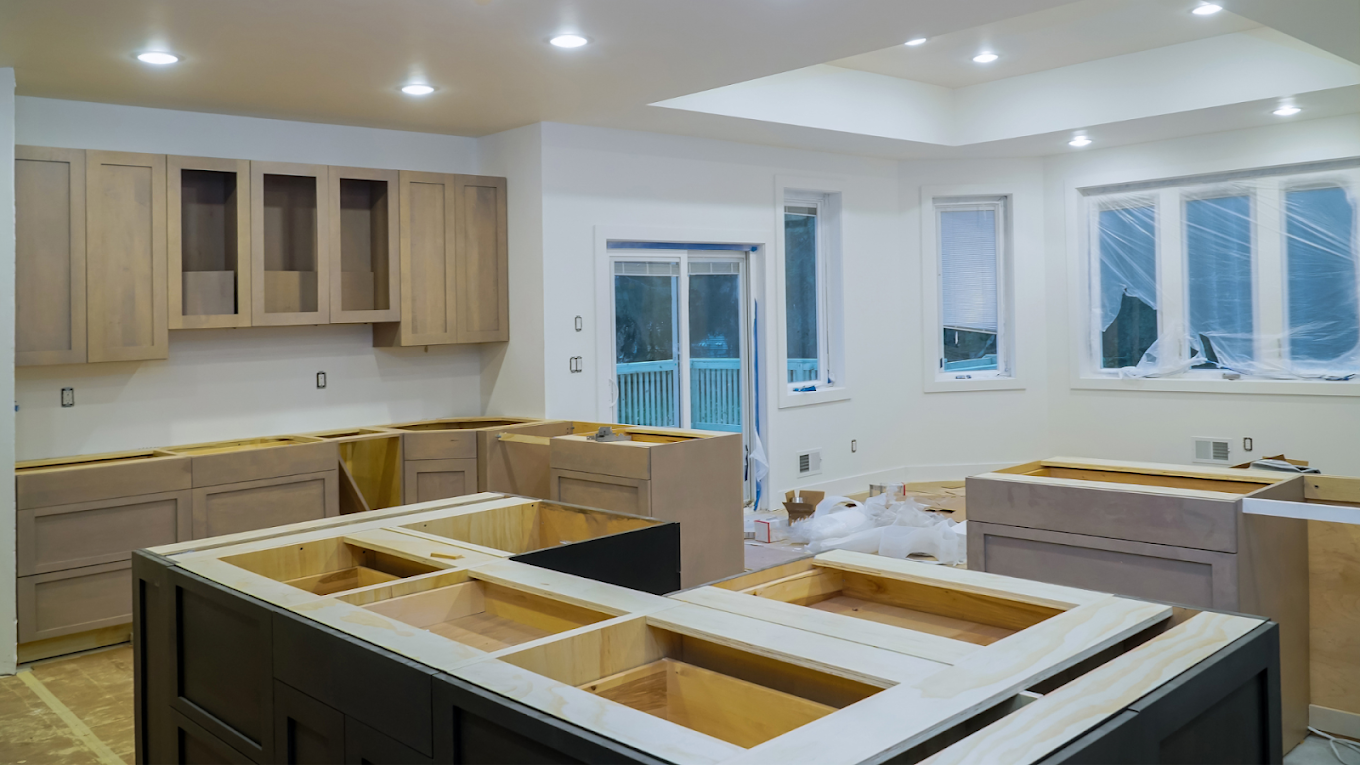 Custom kitchen cabinetry with island base, awaiting countertops.